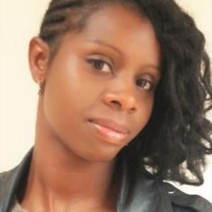 Denise Francis-Brown wearing a black leather jacket and her hair is swept to one side